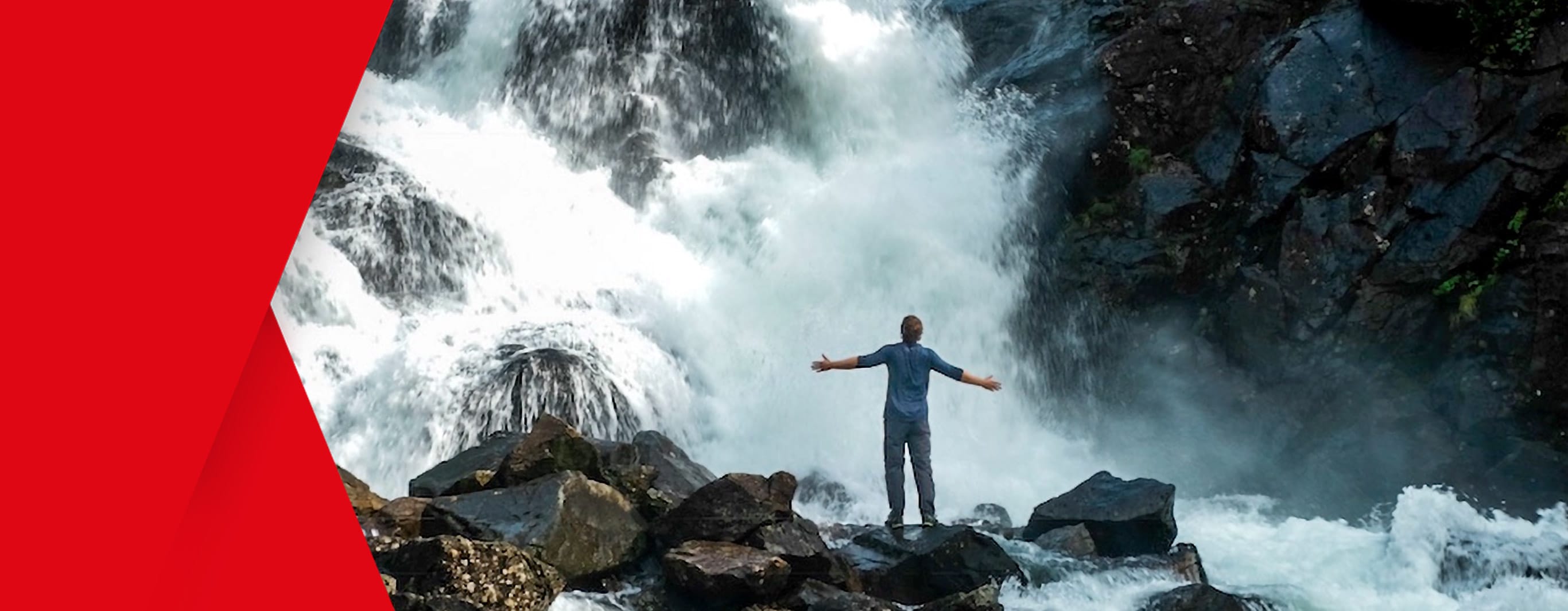 The figure of a man, arms outstretched, is seen standing in front of a huge gushing waterfall 'welcoming' the raging torrents